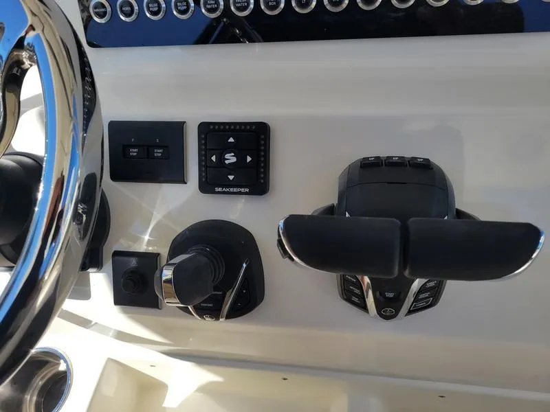 Slide: The Image of 2025 Key West 291 FS boat dashboard with controls and steering wheel. - 16