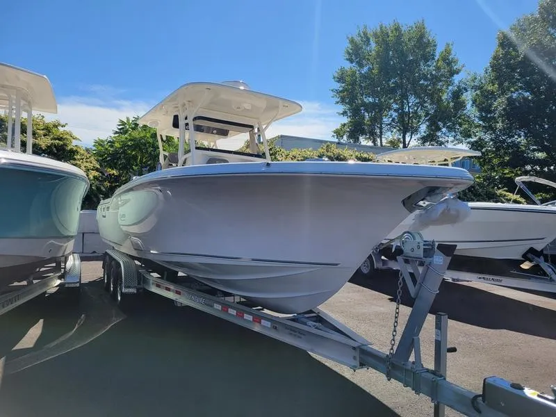 Slide: The Image of 2025 Key West 291 FS boat on trailer, parked outdoors under clear sky. - 6