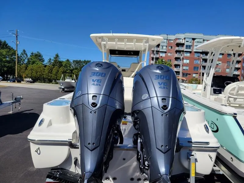 Slide: The Image of 2025 Key West 291 FS boat with twin 300 V6 engines, parked outdoors. - 8