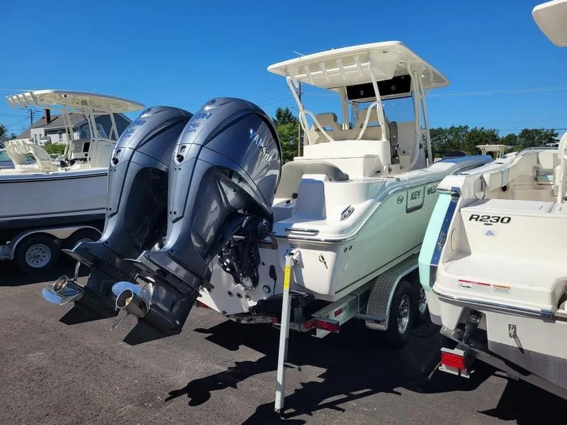 Slide: The Image of 2025 Key West 291 FS boat with dual outboard motors on a trailer. - 9