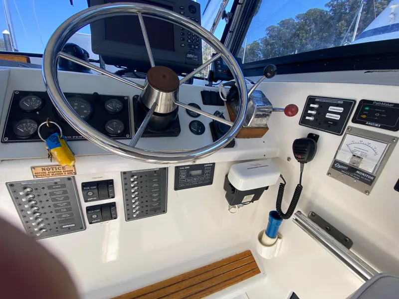 Slide: The Image of 1986 Luhrs Alura helm with steering wheel, gauges, and navigation equipment. - 11
