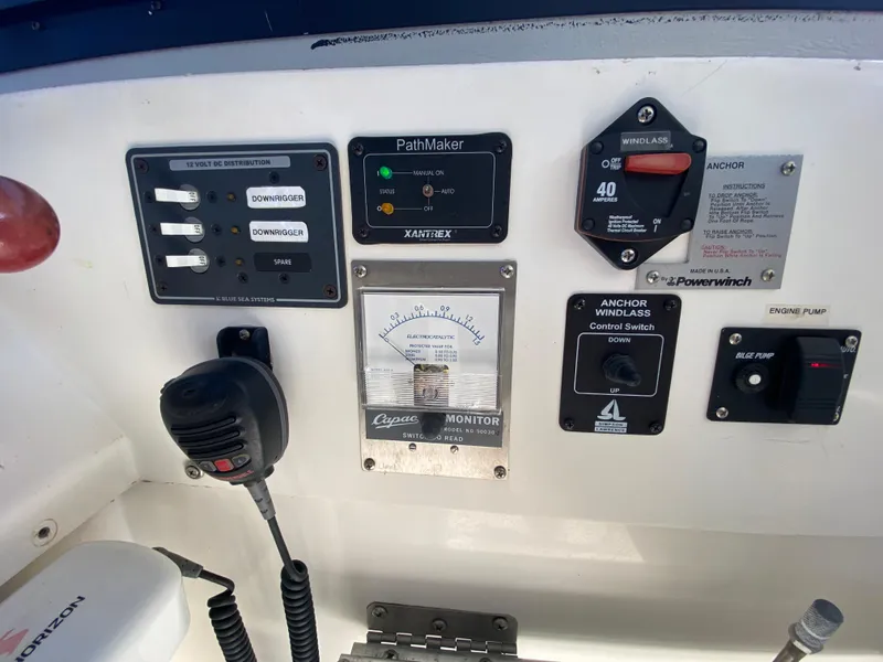 Slide: The Image of Control panel of a 1986 Luhrs Alura boat with various switches and gauges. - 13