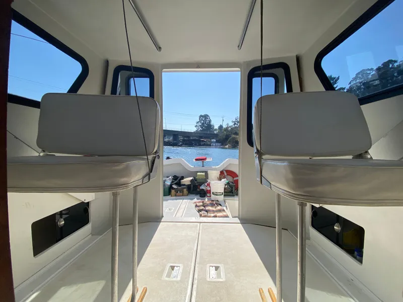Slide: The Image of Interior view of 1986 Luhrs Alura boat with seating and windows overlooking water. - 14