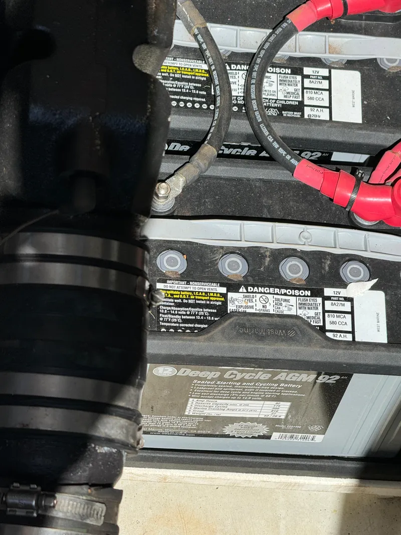 Slide: The Image of 1986 Luhrs Alura boat batteries with cables and labels visible. - 23