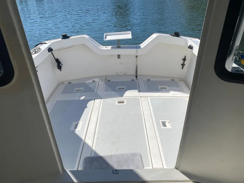 Slide: The Image of 1986 Luhrs Alura boat deck with open space, overlooking calm water. - 5