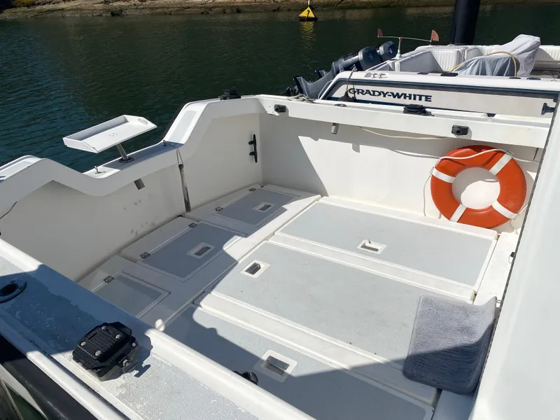 Slide: The Image of 1986 Luhrs Alura boat deck with life preserver and storage compartments. - 6