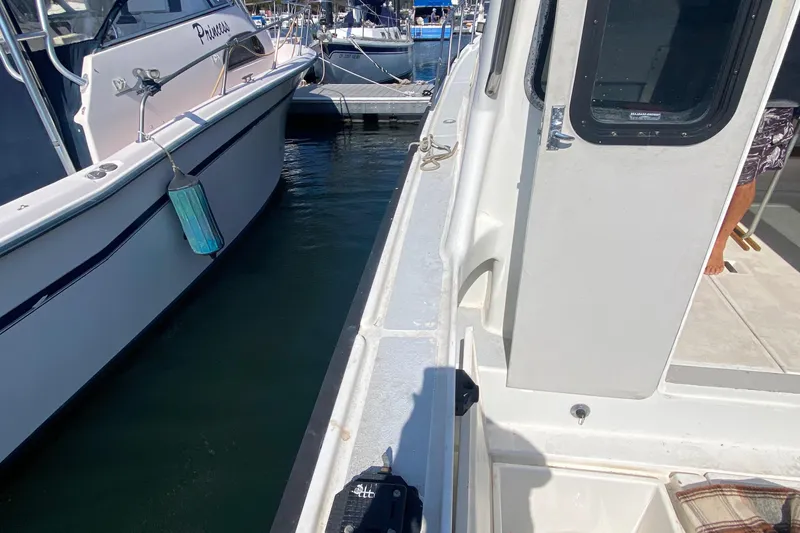 Slide: The Image of 1986 Luhrs Alura boat docked beside another vessel in a marina. - 7