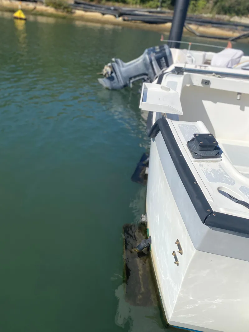 Slide: The Image of 1986 Luhrs Alura boat docked in calm waters, rear view. - 9