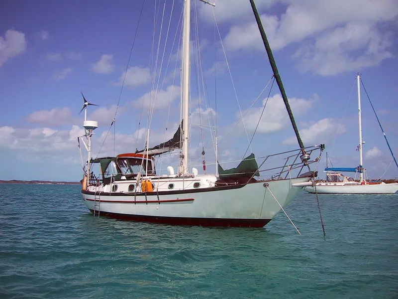 Slide: The Image of 1988 Pacific Seacraft Cutter sailboat anchored in clear blue waters under a sunny sky. - 2