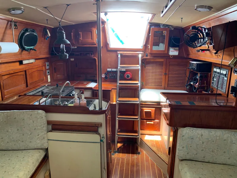 Slide: The Image of Interior of 1988 Pacific Seacraft Cutter sailboat with wooden cabinetry and nautical decor. - 6