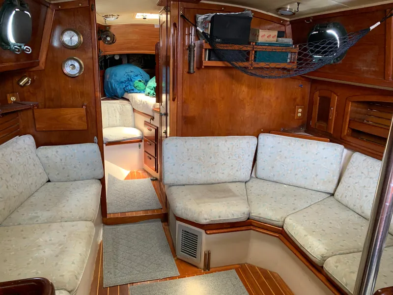 Slide: The Image of Interior of 1988 Pacific Seacraft Cutter sailboat with cozy seating and wooden finishes. - 8