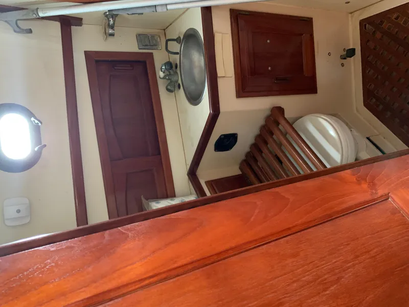 Slide: The Image of Interior of 1988 Pacific Seacraft Cutter, featuring wooden cabinetry and nautical fixtures. - 9
