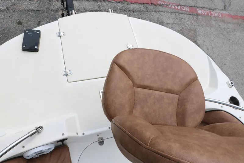 Slide: The Image of 2020 Stingray 212SC boat with brown leather seat and white deck. - 15