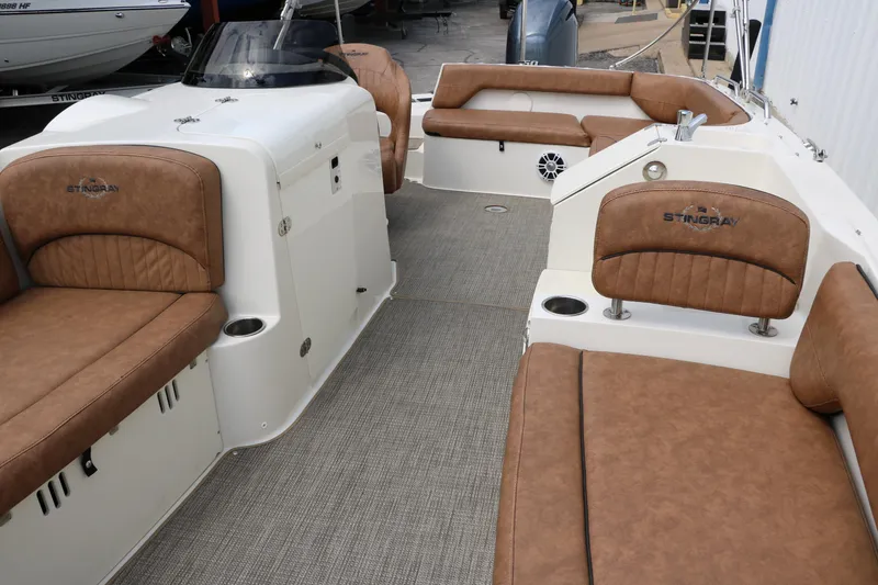 Slide: The Image of 2020 Stingray 212SC boat interior with tan leather seating and spacious layout. - 16