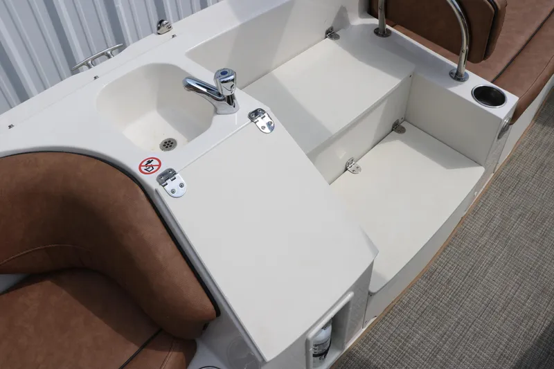 Slide: The Image of 2020 Stingray 212SC boat interior with sink and seating area. - 19