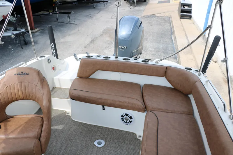 Slide: The Image of 2020 Stingray 212SC boat with brown leather seating and Yamaha F150 outboard motor. - 27