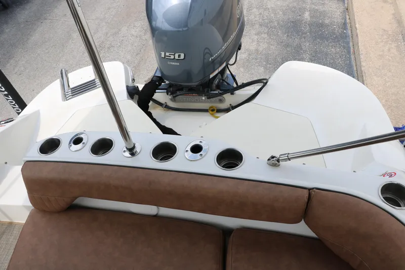 Slide: The Image of 2020 Stingray 212SC boat with Yamaha 150 outboard motor and rod holders. - 30