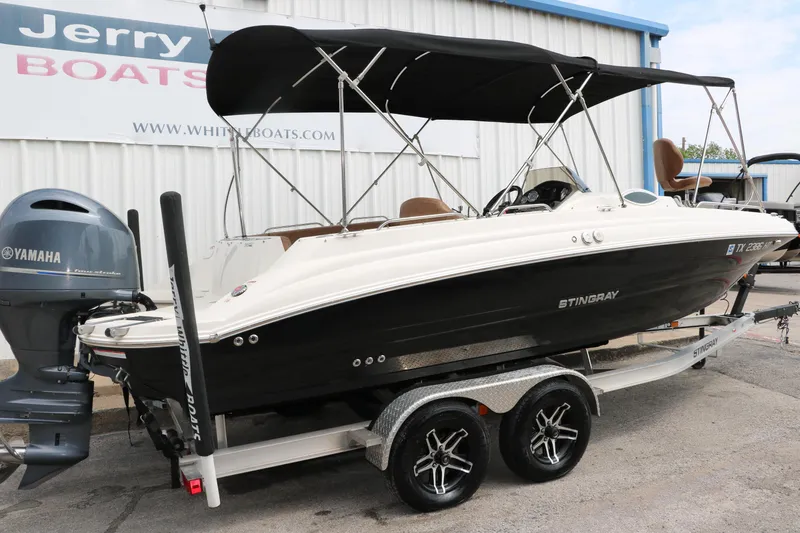 Slide: The Image of 2020 Stingray 212SC boat on trailer with Yamaha outboard motor. - 34