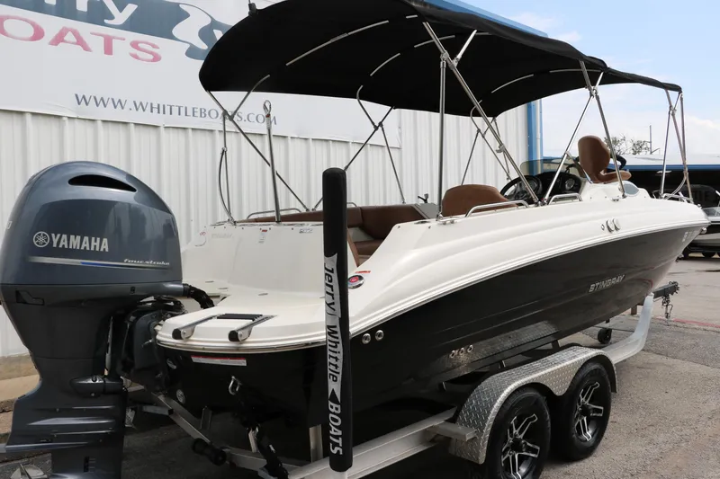Slide: The Image of 2020 Stingray 212SC boat with Yamaha outboard motor on a trailer. - 35