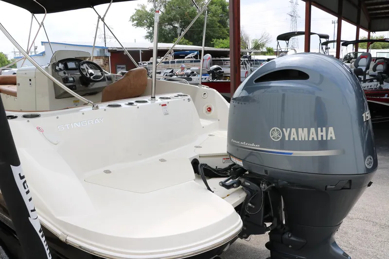 Slide: The Image of 2020 Stingray 212SC boat with Yamaha outboard motor in a marina. - 39