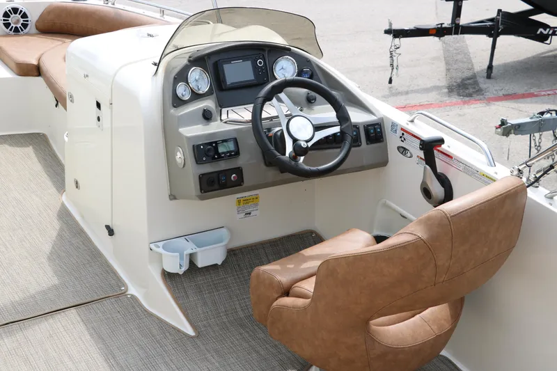 Slide: The Image of 2020 Stingray 212SC boat cockpit with steering wheel and control panel - 4