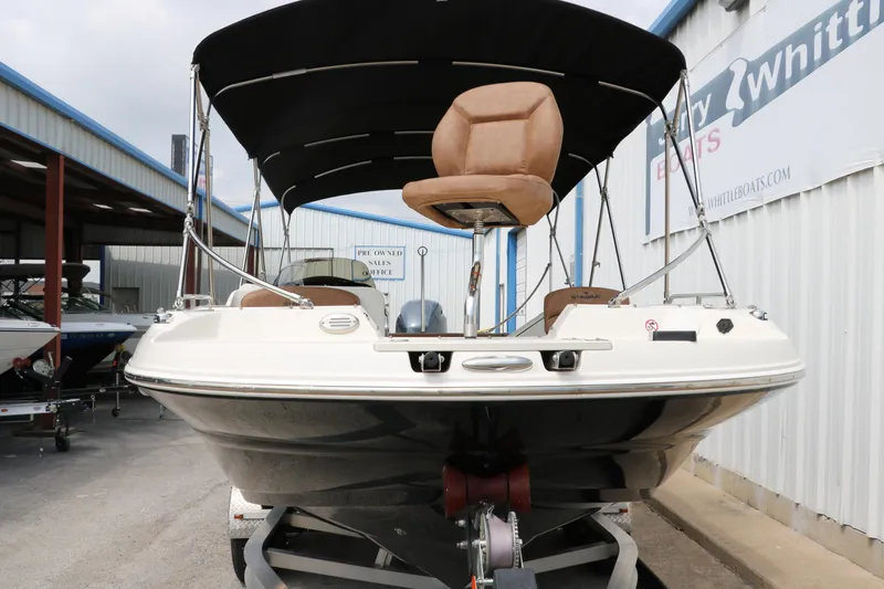 Slide: The Image of 2020 Stingray 212SC boat with canopy on trailer at dealership. - 43