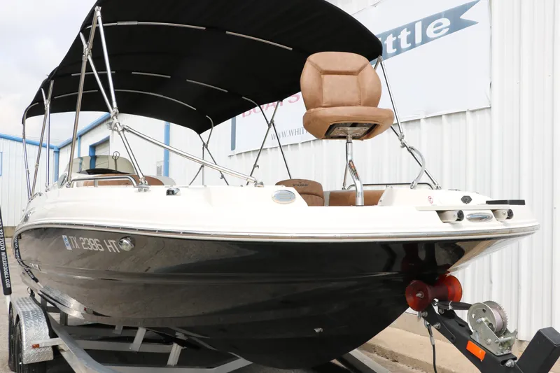 Slide: The Image of 2020 Stingray 212SC boat on trailer with canopy and seating. - 44