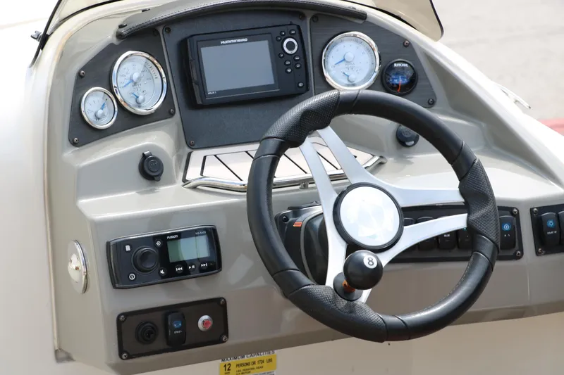 Slide: The Image of 2020 Stingray 212SC boat dashboard with steering wheel and navigation instruments. - 8