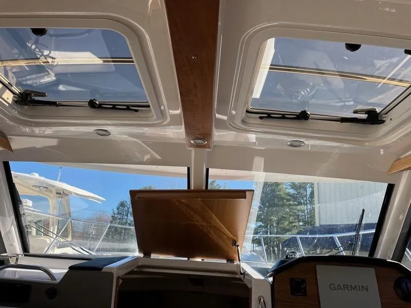 Slide: The Image of Interior view of 2025 Cutwater C-248 C Coupe with sunroof and Garmin navigation system. - 2