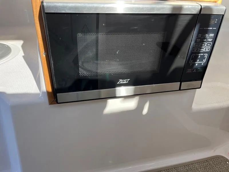 Slide: The Image of Microwave installed in 2025 Cutwater C-248 C (COUPE) boat interior. - 3