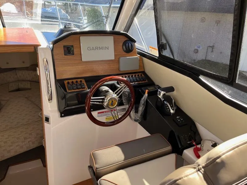 Slide: The Image of 2025 Cutwater C-248 C Coupe interior with Garmin navigation and steering wheel. - 8