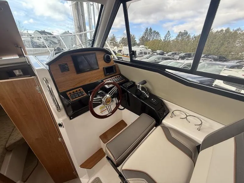 Slide: The Image of 2025 Cutwater C-248 C Coupe interior with steering wheel and navigation controls. - 16