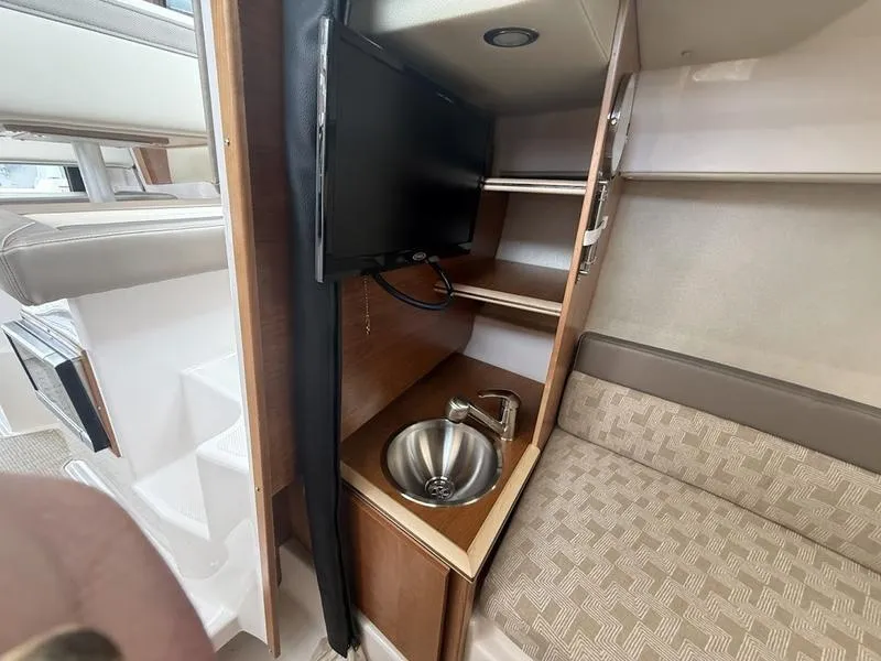 Slide: The Image of 2025 Cutwater C-248 C interior with sink, TV, and seating area. - 17