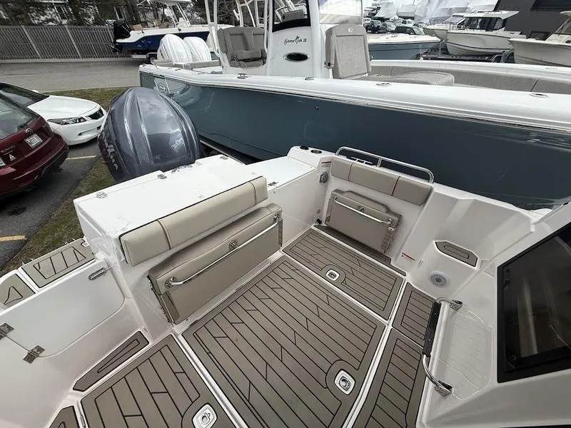 Slide: The Image of 2025 Cutwater C-248 C Coupe boat interior with cushioned seating and wood-patterned flooring. - 7