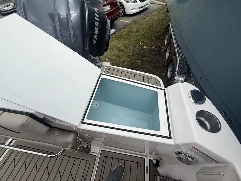 Slide: The Image of 2025 Cutwater C-248 C (COUPE) boat with open storage compartment and Yamaha engine. - 9