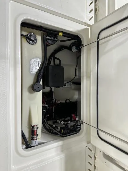 Slide: The Image of 2024 Boston Whaler 240 Vantage boat compartment with wiring and components. - 18