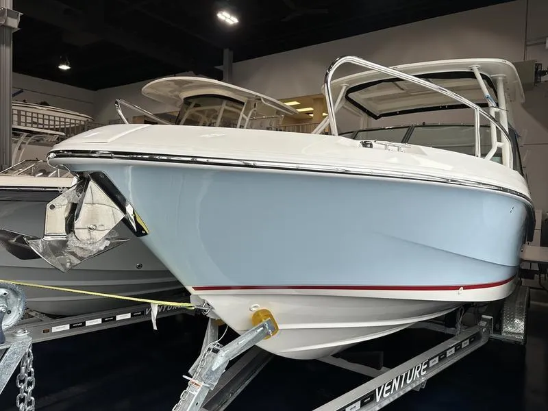 Slide: The Image of 2024 Boston Whaler 240 Vantage boat on trailer in showroom. - 2