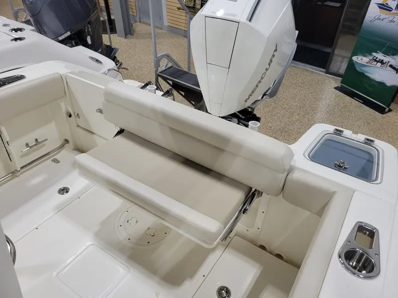 Slide: The Image of 2025 Boston Whaler 230 Outrage boat interior with seating and engine view. - 15