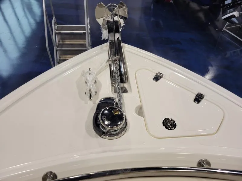 Slide: The Image of 2025 Boston Whaler 230 Outrage boat bow with anchor and storage compartments. - 16