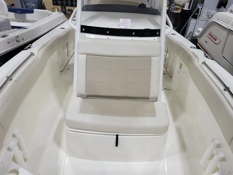 Slide: The Image of 2025 Boston Whaler 230 Outrage boat interior with cushioned seating. - 17