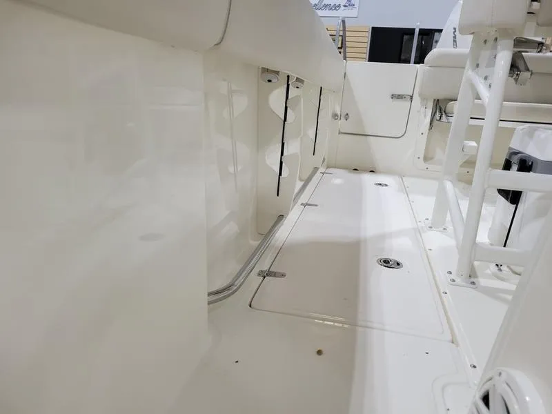 Slide: The Image of 2025 Boston Whaler 230 Outrage boat interior, showcasing sleek white deck design. - 18