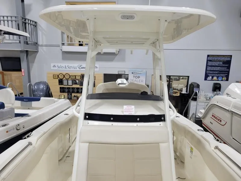 Slide: The Image of 2025 Boston Whaler 230 Outrage boat interior at dealership showroom. - 19