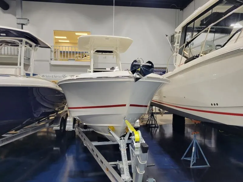Slide: The Image of 2025 Boston Whaler 230 Outrage boat on display in showroom. - 2