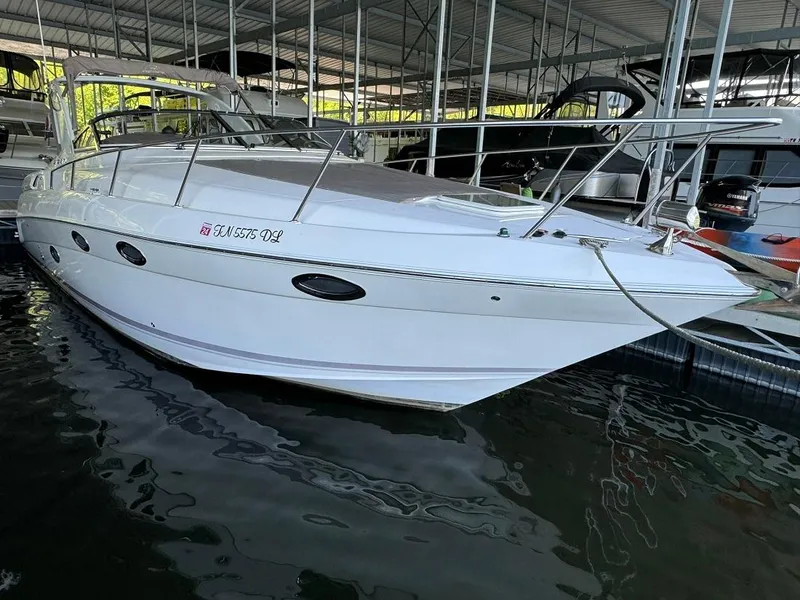 The Image of 2004 Regal 3260 Commodore boat docked in a marina. - 1