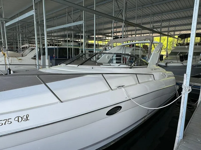 Slide: The Image of 2004 Regal 3260 Commodore yacht docked in a marina. - 11