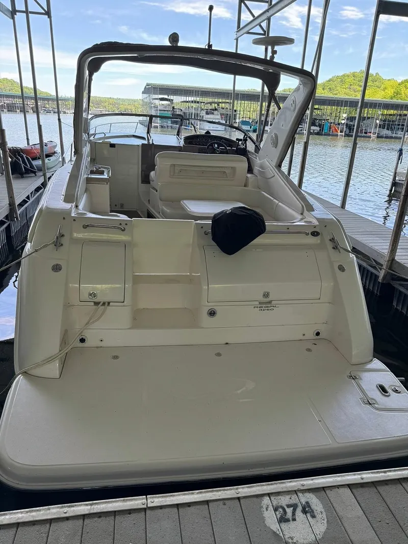 Slide: The Image of 2004 Regal 3260 Commodore boat docked at a marina. - 12