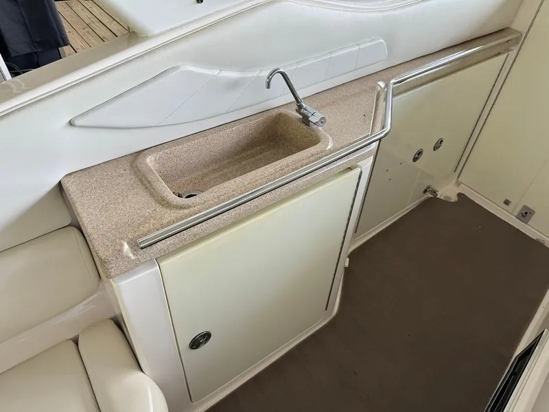Slide: The Image of 2004 Regal 3260 Commodore boat interior with sink and storage cabinets. - 15
