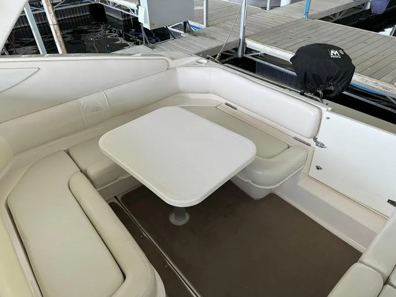 Slide: The Image of 2004 Regal 3260 Commodore boat interior with white seating and table. - 17
