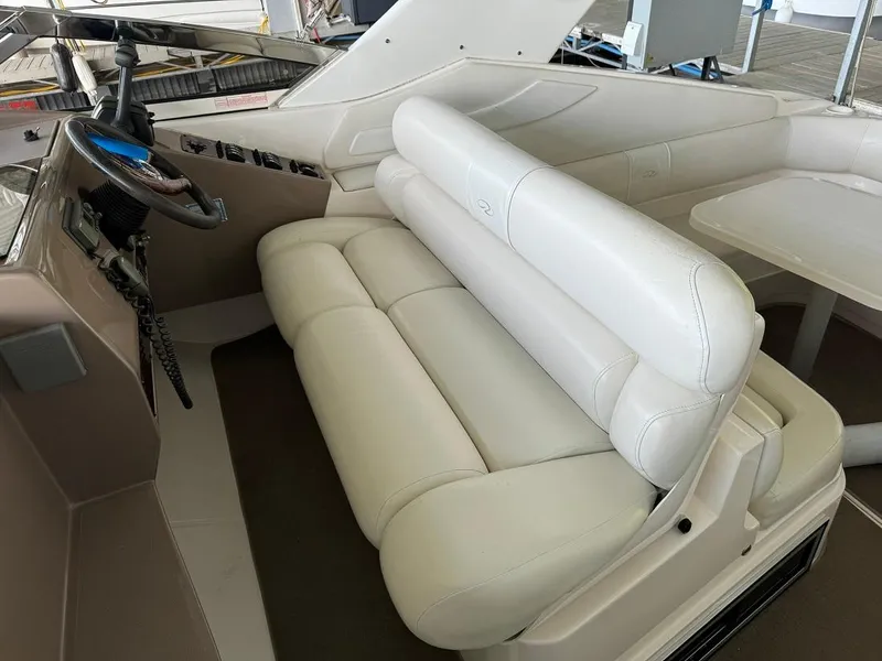 Slide: The Image of 2004 Regal 3260 Commodore boat interior with white leather seating and steering wheel. - 19