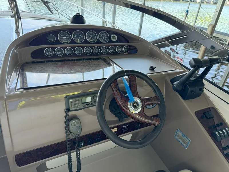 Slide: The Image of 2004 Regal 3260 Commodore boat helm with steering wheel and control panel. - 22